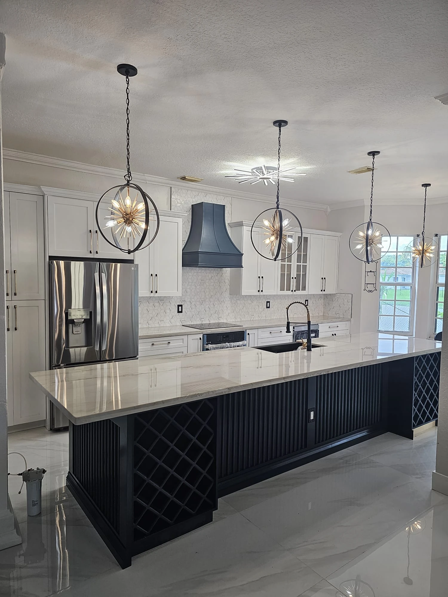Oversized island with built-in wine rack and white shaker cabinets