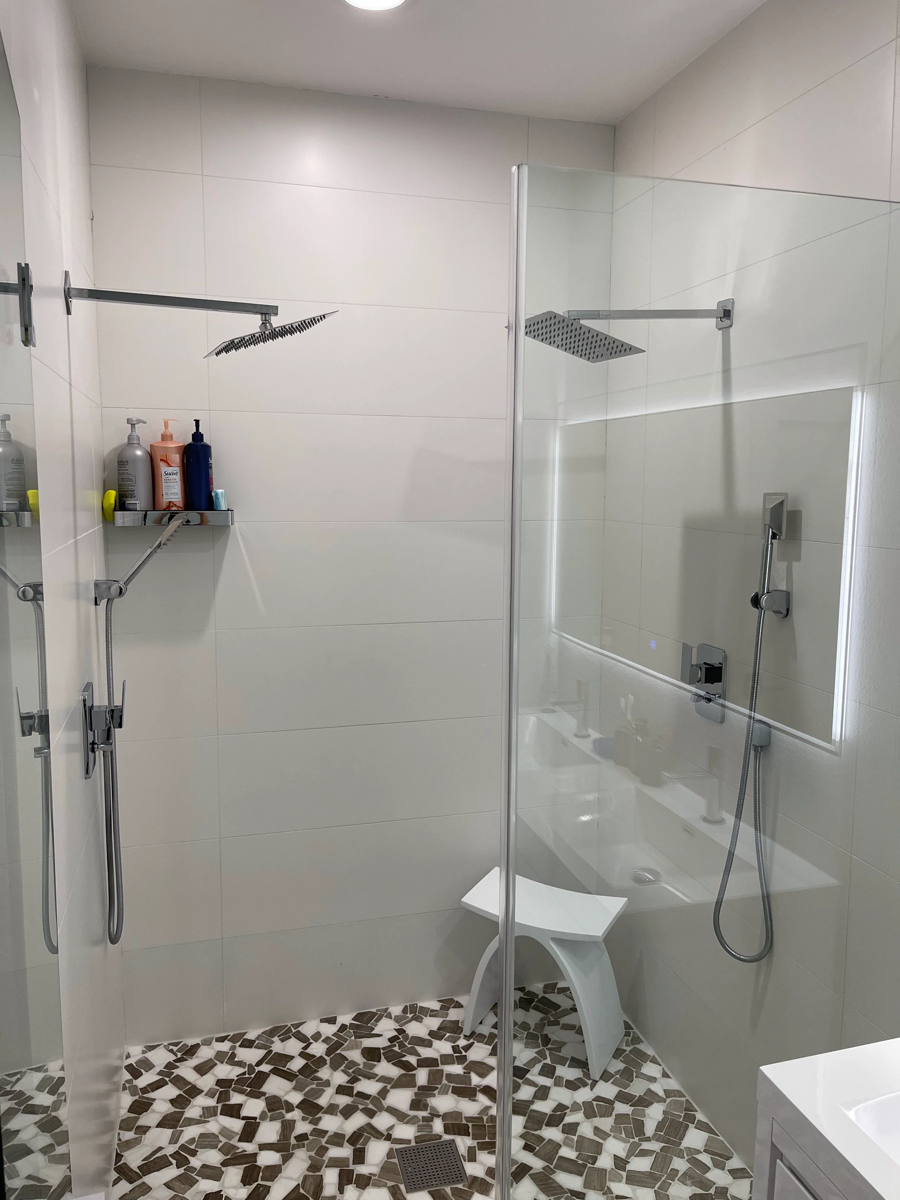 Walk-in shower with rainfall head, handheld shower and mosaic floor
