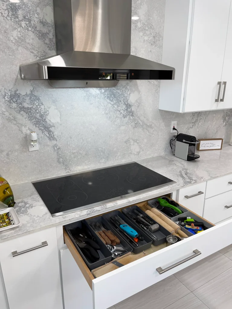 Utensil drawer organizer below an induction cooktop