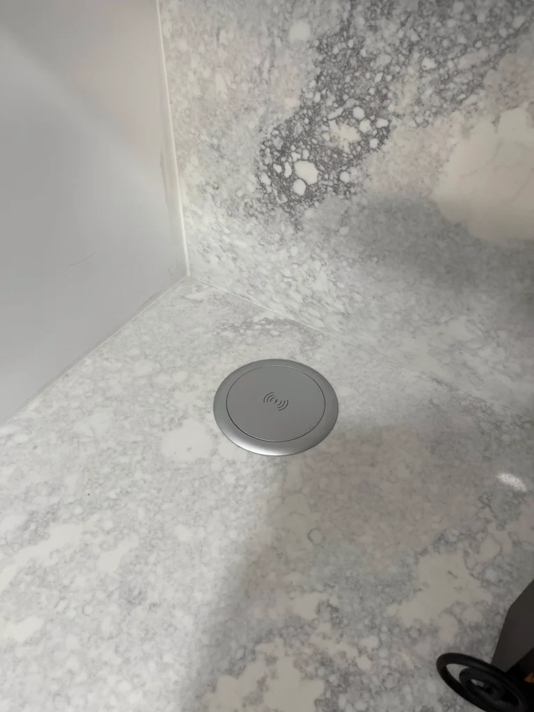 Wireless charging pad set flush into a quartz countertop
