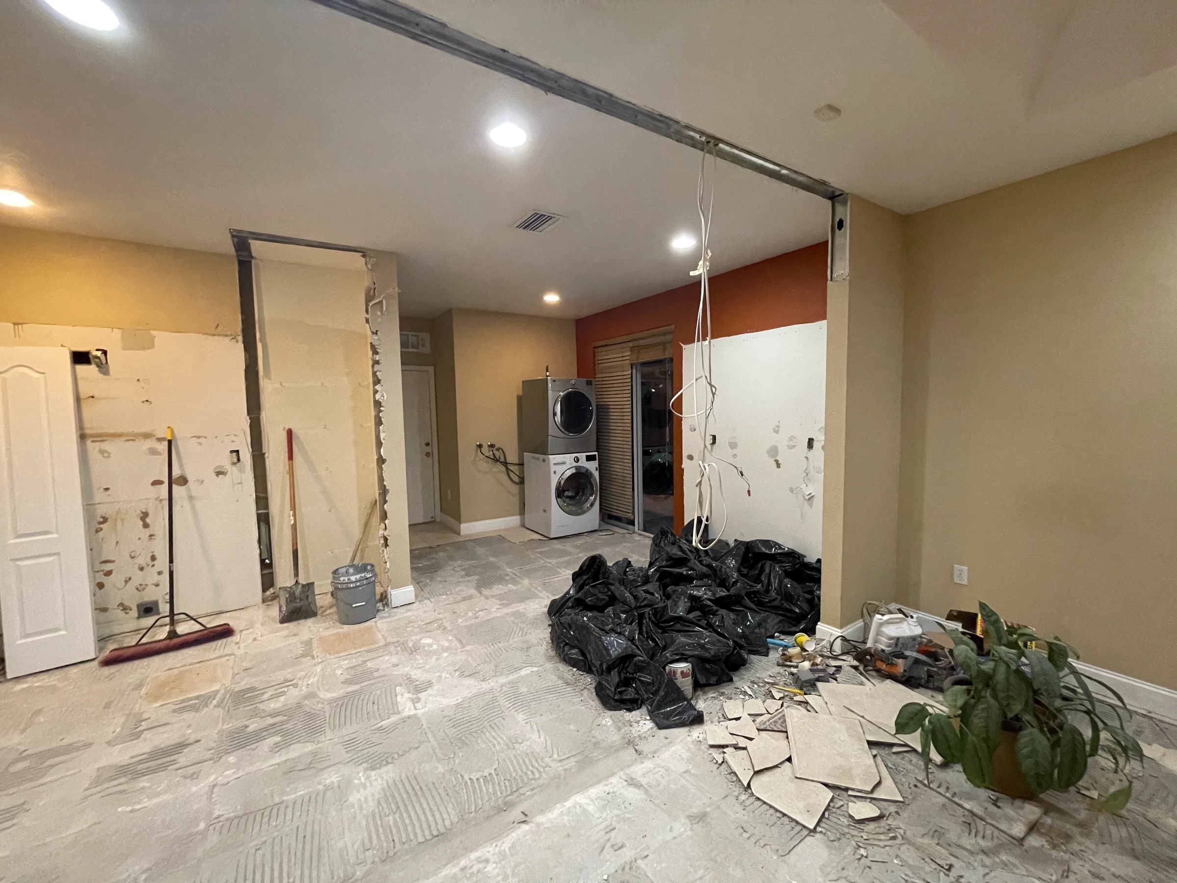 Kitchen area during demolition, walls opened and floor stripped