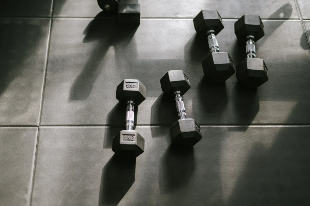 Hex dumbbells on a dark rubber gym floor