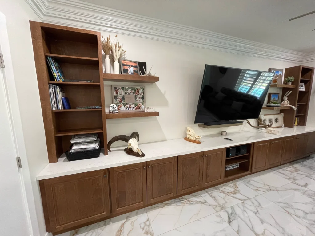 Custom wood media wall with open shelving and a floating TV