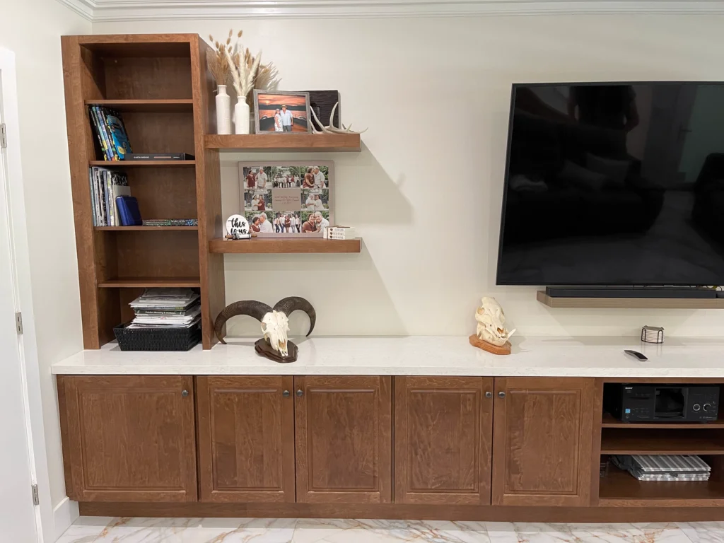 Custom wood media console with bookcase and floating shelves