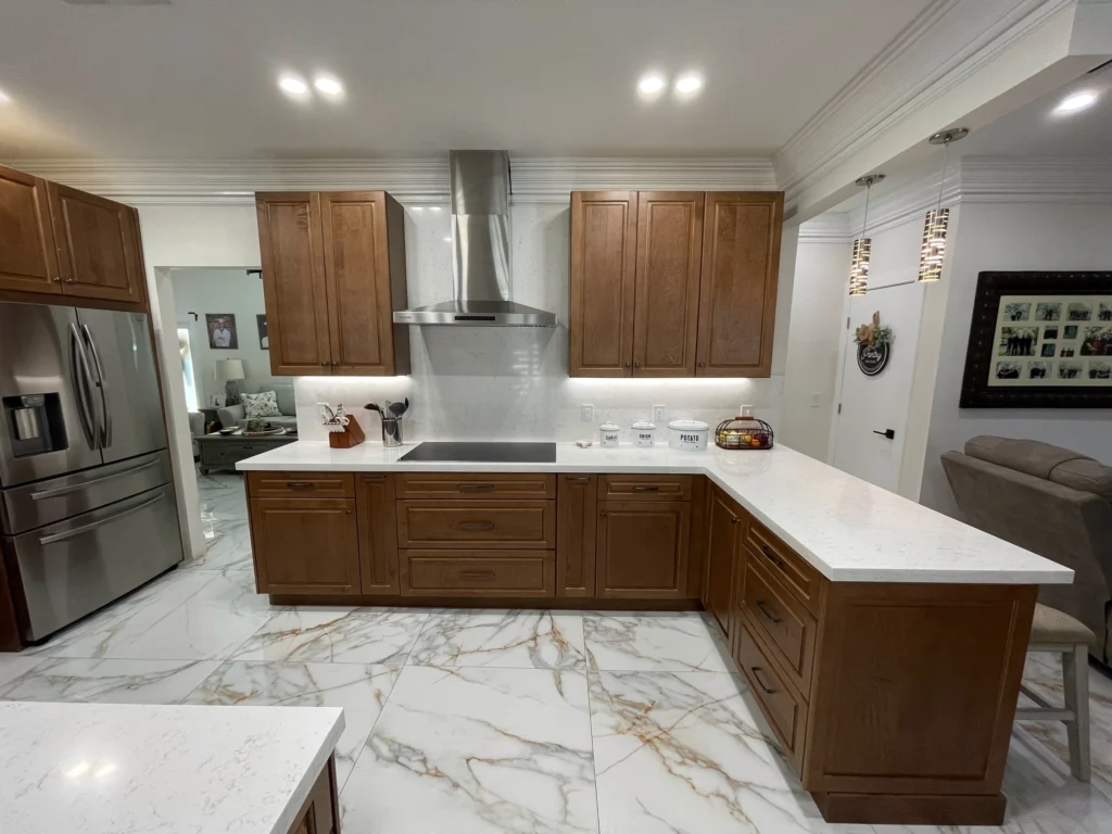 U-shaped kitchen with wood cabinets and white quartz counters