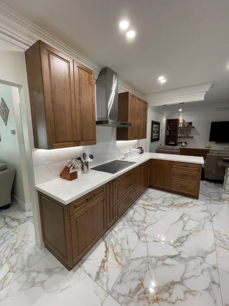 L-shaped run of wood cabinets with under-cabinet lighting
