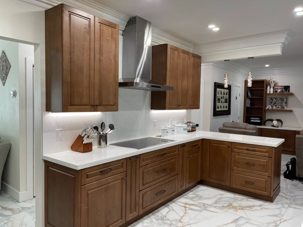 Wood kitchen cabinets and stainless hood seen from the dining side